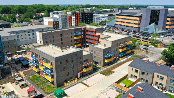 Aerial shot of flats with yellow, red and blue balconies 